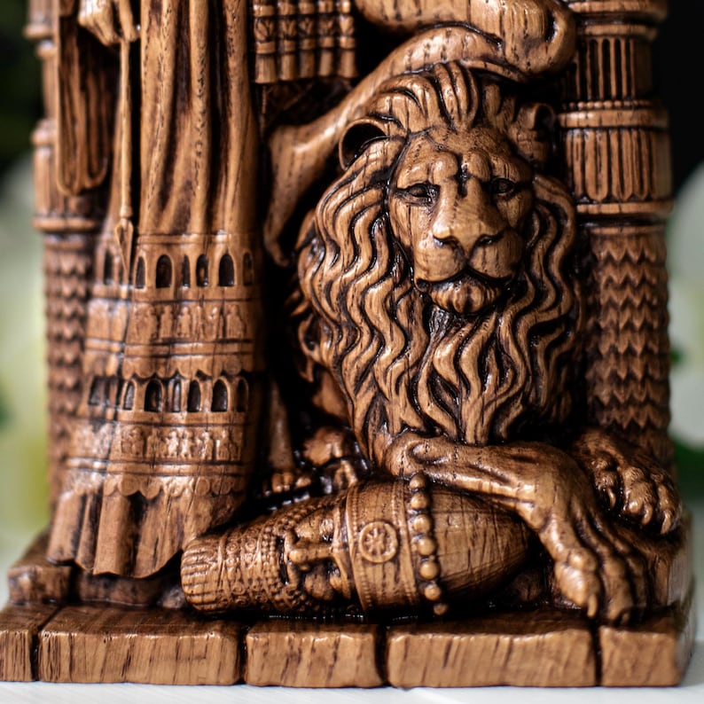 May include: A detailed, brown, carved statue featuring a lion with a flowing mane and a regal pose. The statue has intricate details, including architectural elements and decorative patterns. The lion's paw rests on a cylindrical object.