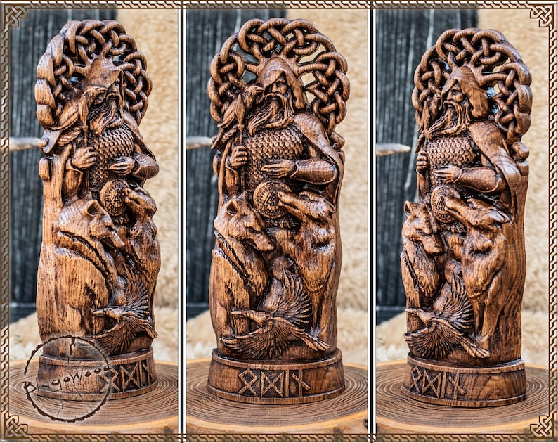 May include: A detailed wooden carving of a figure with a beard, holding a coin, and surrounded by wolves and ravens. The carving has intricate knotwork and is displayed on a wooden base. The wood has a warm, brown tone.
