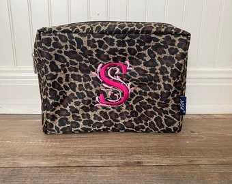 May include: Leopard print cosmetic bag with a pink embroidered letter "S" and a blue "Made" label.