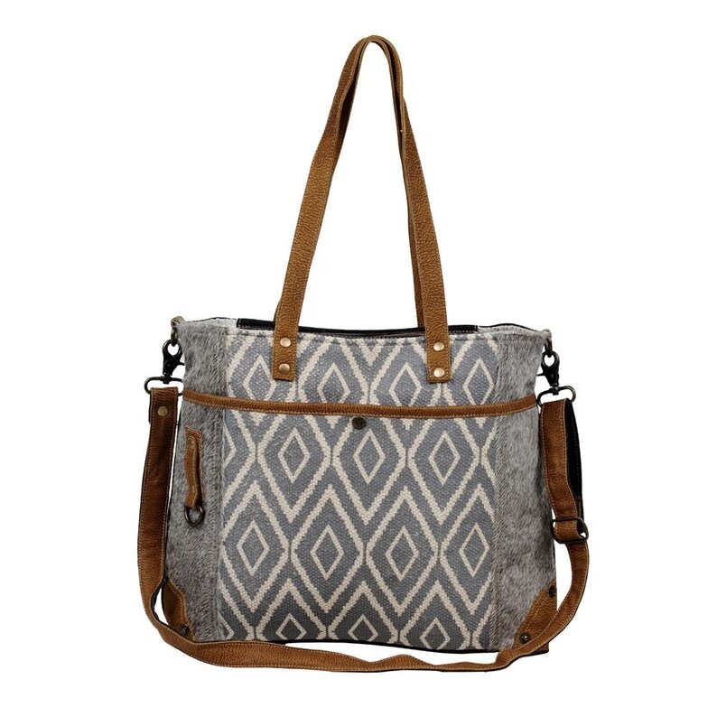 May include: A gray and white geometric patterned tote bag with brown leather straps and a detachable shoulder strap.