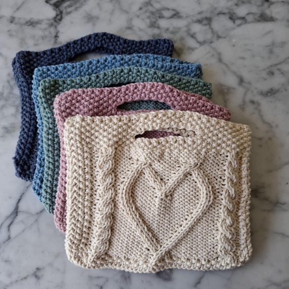 Small knit handbag with cable heart design. Handknit bag in soft cotton, can be worn on wrist. Light summer handmade bag.