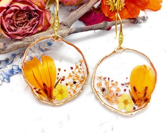 Women's gold brass pendant hoop earrings with real orange resin flower pendant. Pressed dried flower resin jewelry. Unique gift