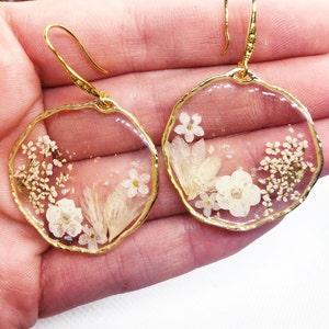 Women's gold brass pendant hoop earrings with real resin flower pendant. Pressed dried flower resin jewelry. Unique gift for her