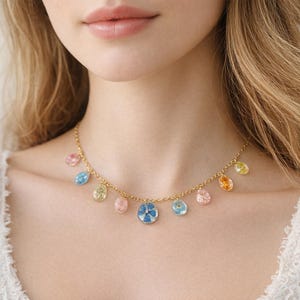 Women's gold necklace with multicolored real flower pendants. Real dried flower jewelry pressed into resin. Unique handmade jewelry accessories.