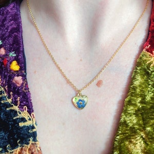 Micro heart pendant necklace with real flowers Forget me not opal flakes in resin. Golden steel chain Forget-me-not flower jewelry