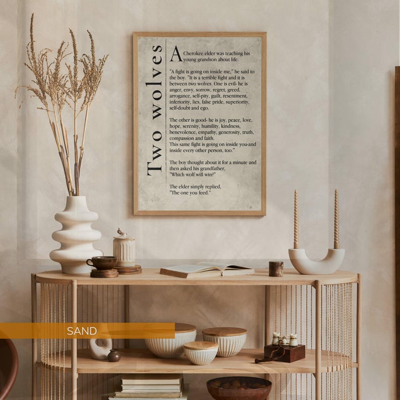 a framed quote on a wall, with a wooden shelf below it containing various objects such as a vase, candles, and a bowl.