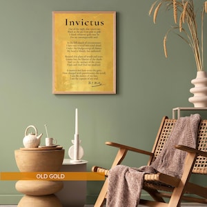 a cozy living room setting with a framed quote ofInvictus by William Shakespeare hanging on the wall. The room has a wooden chair, a wooden side table, and a vase with dried flowers. The overall color scheme is a combination of green and brown tones, creating a warm and inviting atmosphere.