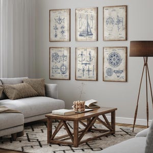 May include: Six framed nautical-themed prints with blue and white illustrations on aged paper. The prints depict various maritime designs, including a sailboat, compass, and mechanical diagrams. The frames are a warm brown color, and the prints are displayed on a neutral wall.