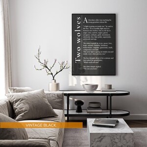 a living room with a gray sofa, a black coffee table, and a framed quote on the wall.