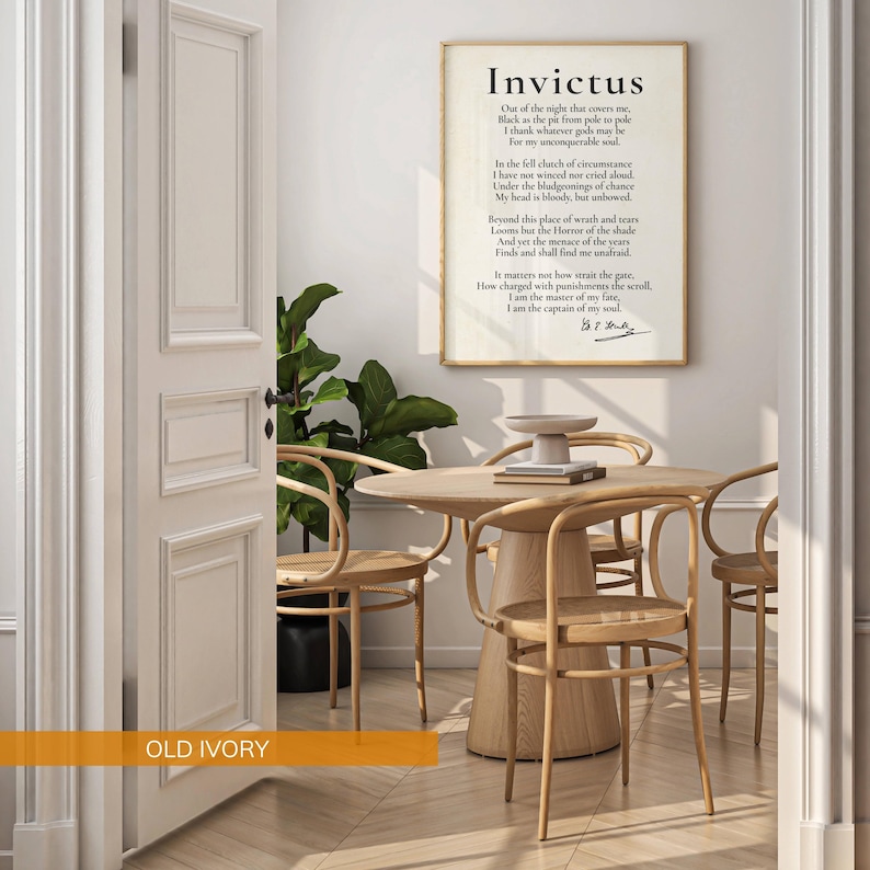 a room with a wooden table and chairs, a potted plant, and a framed quote on the wall.