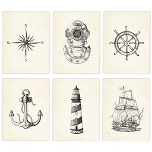 May include: Set of six nautical-themed prints featuring detailed black and white illustrations. The prints depict a compass rose, diving helmet, ship's wheel, anchor, lighthouse, and a sailing ship, all on a vintage-style cream background.
