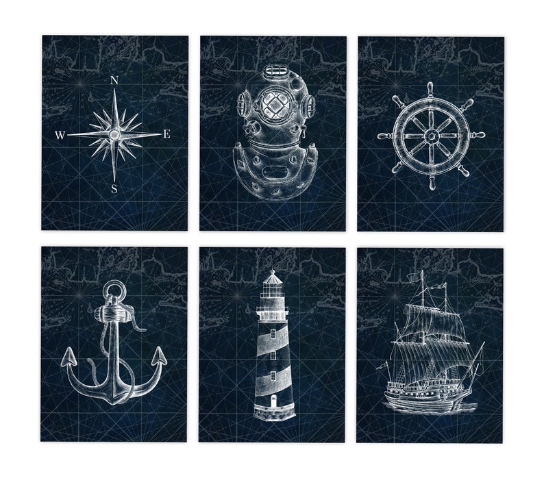 May include: Six nautical-themed prints featuring white line drawings on a dark blue background. The images include a compass rose, diving helmet, ship's wheel, anchor, lighthouse, and a sailboat. The background has a map-like grid.