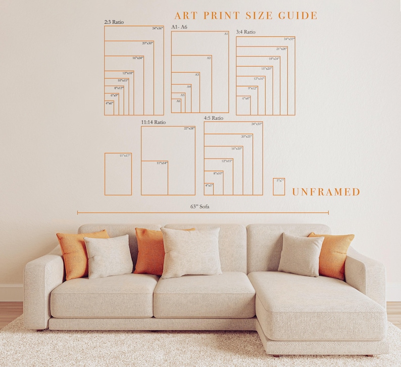The image is a wall decal that provides an art print size guide for different print sizes, including 23, 23/2, 11/14, 4/5, and unframed. The guide is displayed above a beige sectional sofa with orange throw pillows.