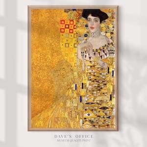 May include: A framed print of a Gustav Klimt painting. The artwork features a woman in a gold dress with intricate patterns and a black hat. The background is a mix of gold and yellow tones. The print is labeled "DAVE'S OFFICE MUSEUM QUALITY PRINT."