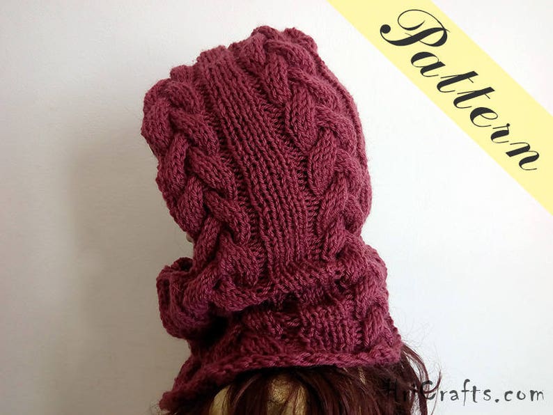 May include: A burgundy knitted cowl neck hat with a cable knit pattern.