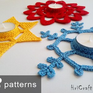 May include: Three crocheted candle holders in the shapes of a star, snowflake, and flower. The star is yellow, the snowflake is blue, and the flower is red. Each holder has a small, round indentation in the center to hold a tea light candle.