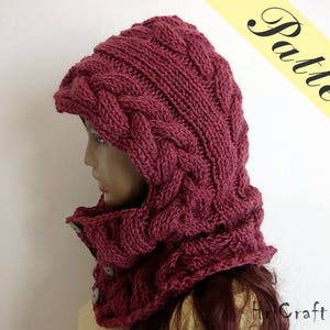 May include: A burgundy knitted hooded cowl with a cable knit pattern. The cowl is made of soft yarn and has a warm, cosy feel.
