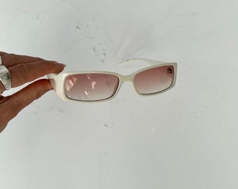 May include: White rectangular sunglasses with brown gradient lenses.