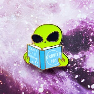 Gravity 101 Book Alien Enamel Pin