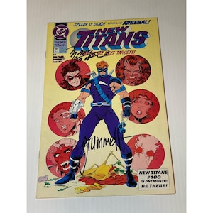 May include: A vintage comic book titled "The New Titans" issue #99. The cover features a costumed superhero in a purple suit with a blue mask, surrounded by circular portraits. The comic book has the text "Speedy is Dead! Long Live Arsenal!"
