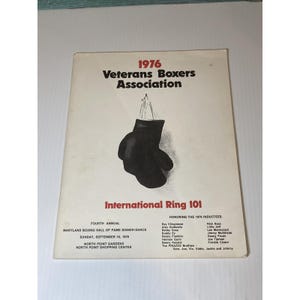 May include: A vintage program cover for the 1976 Veterans Boxers Association. The cover features a black boxing glove graphic and text that reads "International Ring 101". The program is for the Maryland Boxing Hall of Fame Dinner-Dance.