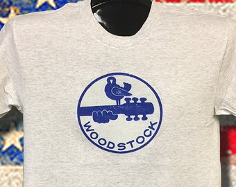 Woodstock 1969 NOS heat transfer applied to a Ash tee. The Rat's Hole sold these in 69 found in the warehouse. Never find these LAST FEW