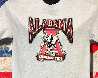 Alabama Crimson Tide Vintage 80's transfer on Ash cotton tee with SEC champs logo with glitter trim. Get ready for the Big Game Vintage time