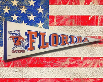 1984 Florida Gator pennant was never sold and stored away over 30 years. Large 12" X 30" no holes or creases little stains. Great for Fans