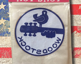 Woodstock 1969 NOS heat transfer never opened. The Rat's Hole sold these in 1969 found in the warehouse. You will never find these anywhere.