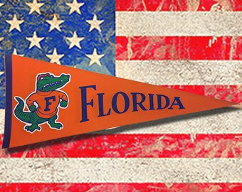 1984 Vintage Florida Gator pennant was never sold and stored away over 30 years. Large 12" X 30" no holes or creases little stains.Go Gators