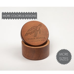 May include: A wooden box with a lid featuring a laser-engraved sea turtle design. The lid also includes the text "Derek Jenner 2 September 2020".
