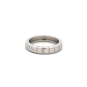 May include: A silver ring with a geometric design. The ring features a series of small, square-shaped segments around the band. The ring is set against a white background, highlighting its metallic sheen and modern aesthetic.