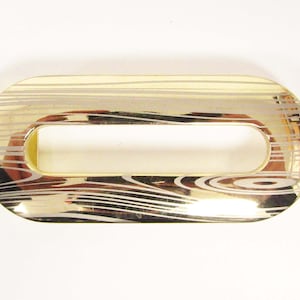 Gold plaque buckle with wispy laser drawn design, made in Italy