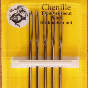 May include: A pack of five John James size 16 Chenille needles on a yellow card. The packaging features the text 5 Needles, JJ18816, Size 16, John James, Est. 1840, Chenille, and Finest Quality Needles, along with a circular logo of a dragon.