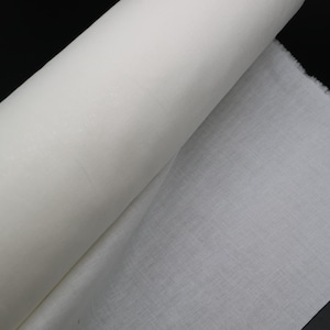 May include: A roll of white fabric, unfurled to show the texture of the material.