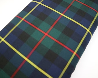 May include: A close-up of a fabric with a plaid pattern in shades of blue, green, yellow, and red.