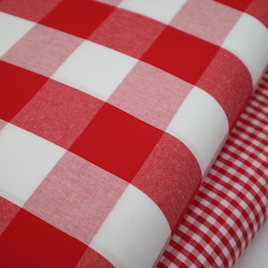 May include: Two red and white gingham fabrics, one with larger squares than the other.