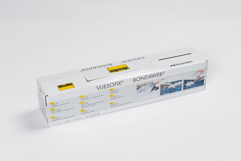 May include: A white box with yellow text that reads "Vliesofix&reg; Bondawweb&reg;" and "Vlieseline". The box shows three images of a person using a white iron to adhere fabric to a blue surface.
