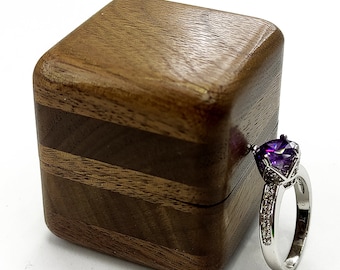 High quality wooden ring box from dark walnut wood . Unique wood engagement ring holder. Art wood ring case proposal.
