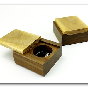 Unique wood engagement ring holder from ash and walnut. Wooden sliding ring box proposal. Compact wooden ring case for gift.
