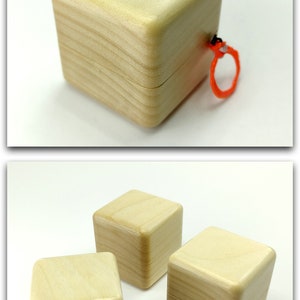 May include: Three wooden boxes with lids. The boxes are square and have a light wood finish. The boxes are all closed and are sitting on a white surface.