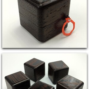 May include: Five small, dark brown wooden boxes with a wood grain pattern. The boxes are arranged in a circle with one box in the center.