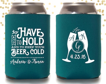 May include: Two teal blue can coolers with white text. One cooler says "to HAVE and to HOLD and to keep your BEER COLD Andrew & Karen". The other cooler has two champagne flutes with the initials "A" and "K" and a circle with the initial "G" inside. The date "4.23.16" is below the flutes.