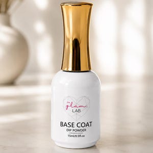 May include: A white bottle of The Glam Lab base coat dip powder with a shiny gold cap. The label features a geometric heart logo, the text "the glam LAB", "BASE COAT", "DIP POWDER", and the volume measurement of 15ml/0.5fl.oz.