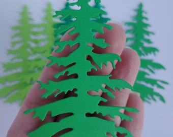 May include: A set of three green paper Christmas trees with a detailed, intricate design. The trees are different sizes and shades of green.