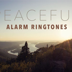 May include: A scenic landscape image with a river winding through a valley, mountains in the background, and a bright sun shining through the clouds. The text "PEACEFUL ALARM RINGTONES" is displayed at the top of the image.
