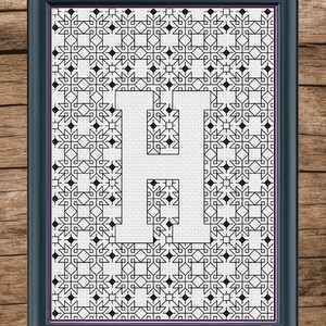 May include: A black and white framed image of the letter H created with a geometric pattern.