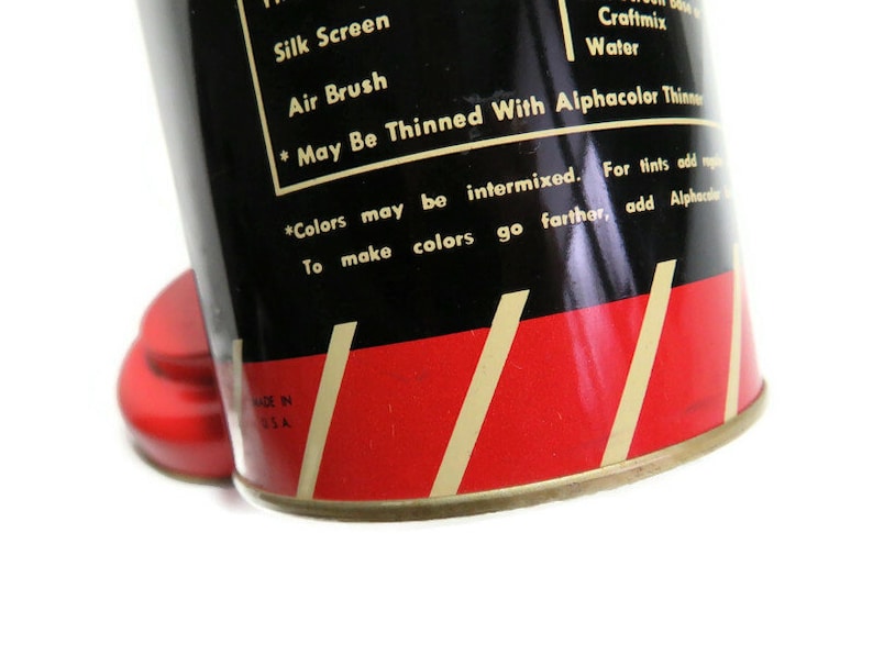 May include: A vintage can of paint with a red and black label. The label says "Silk Screen", "Air Brush", "Craftmix", "Water", "* May Be Thinned With Alphacolor Thinners", "*Colors may be intermixed. For tints add more water. To make colors go farther, add Alphacolor Thinners." The can also says "Made in U.S.A."