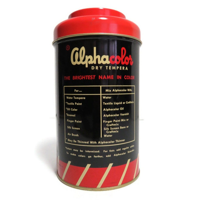 May include: A red and black tin can with the text "Alphacolor Dry Tempera The Brightest Name in Color" on the front. The can lists instructions for mixing the tempera paint with water, textile liquid, oil, varnish, and other mediums.