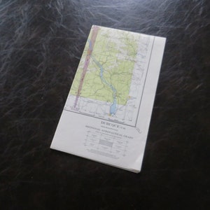 May include: A vintage sectional aeronautical chart for Dubuque, Iowa. The chart is printed on white paper and features a map of the area with green, yellow, and blue markings. The chart is titled "Dubuque, Iowa" and "Sectional Aeronautical Chart".